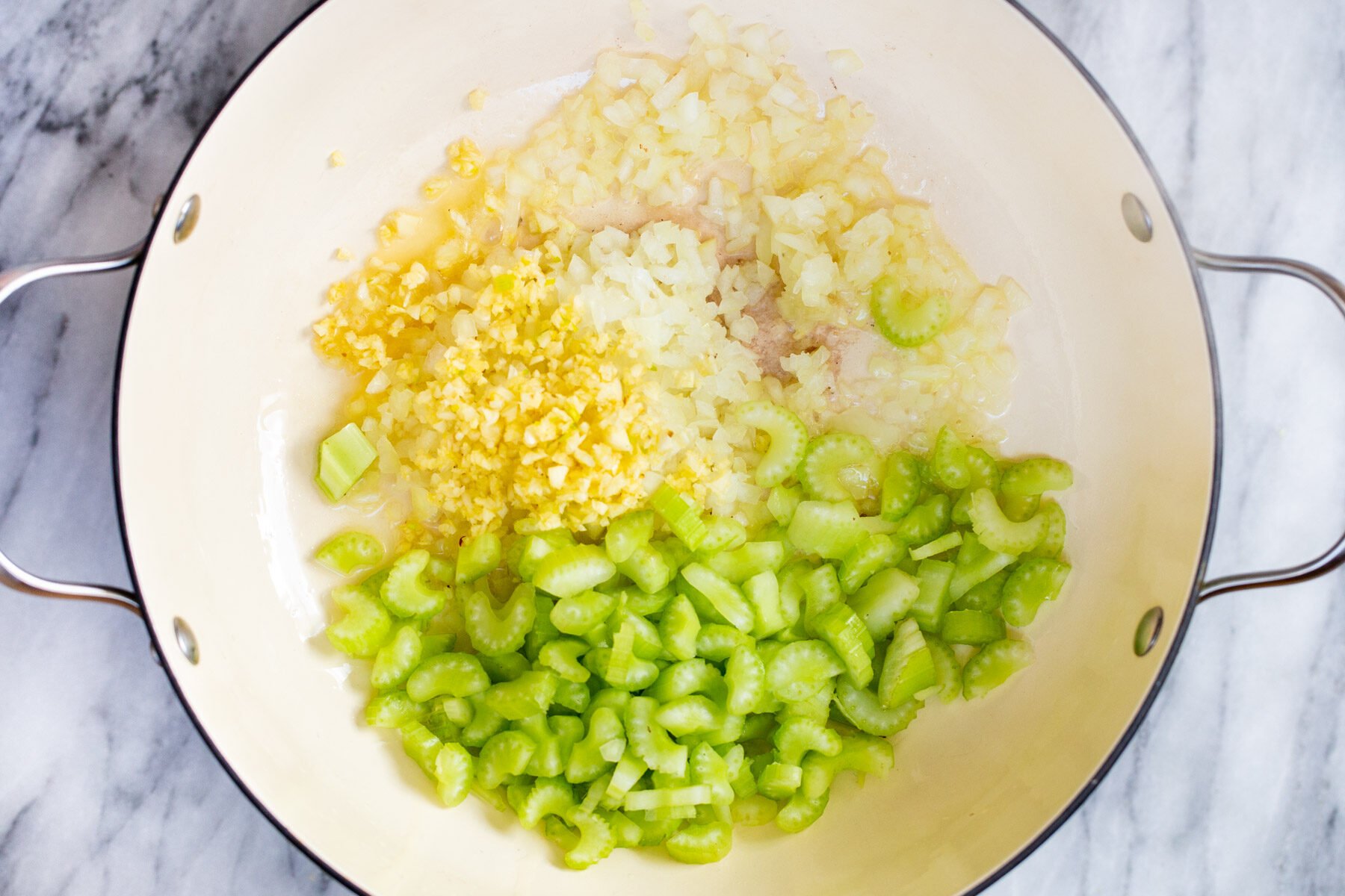 sliced celery, garlic and onion sauteeing in a pot