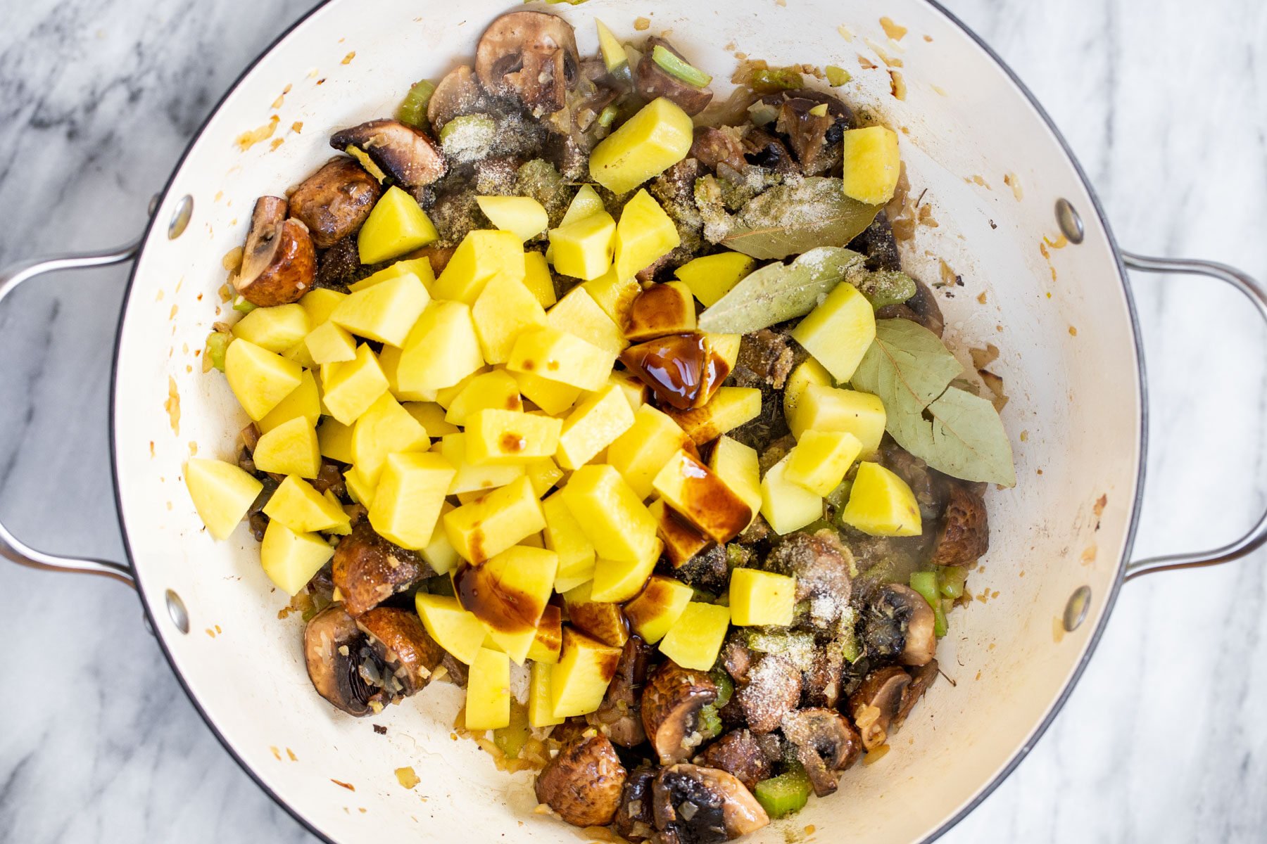 a pot with mushrooms,potatoes and spices