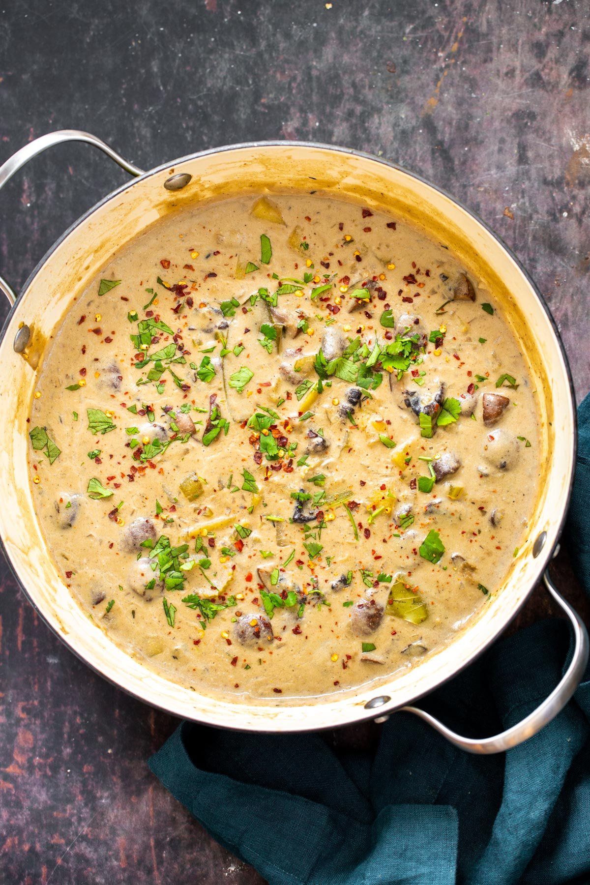 a pot of vegan mushroom chowder sprinkled with sliced green onions