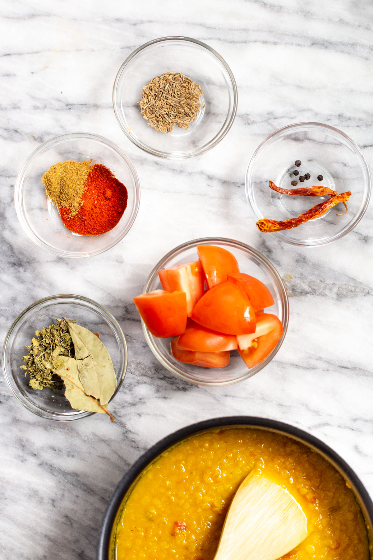 ingredients for making butter daal on a marble surface