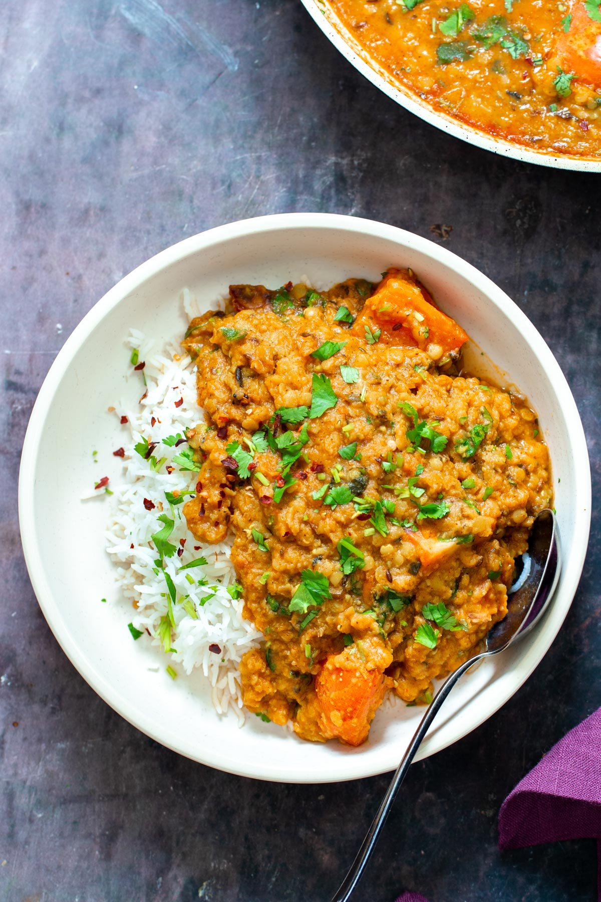 vegan butter daal served with rice and chopped with cilantro 
