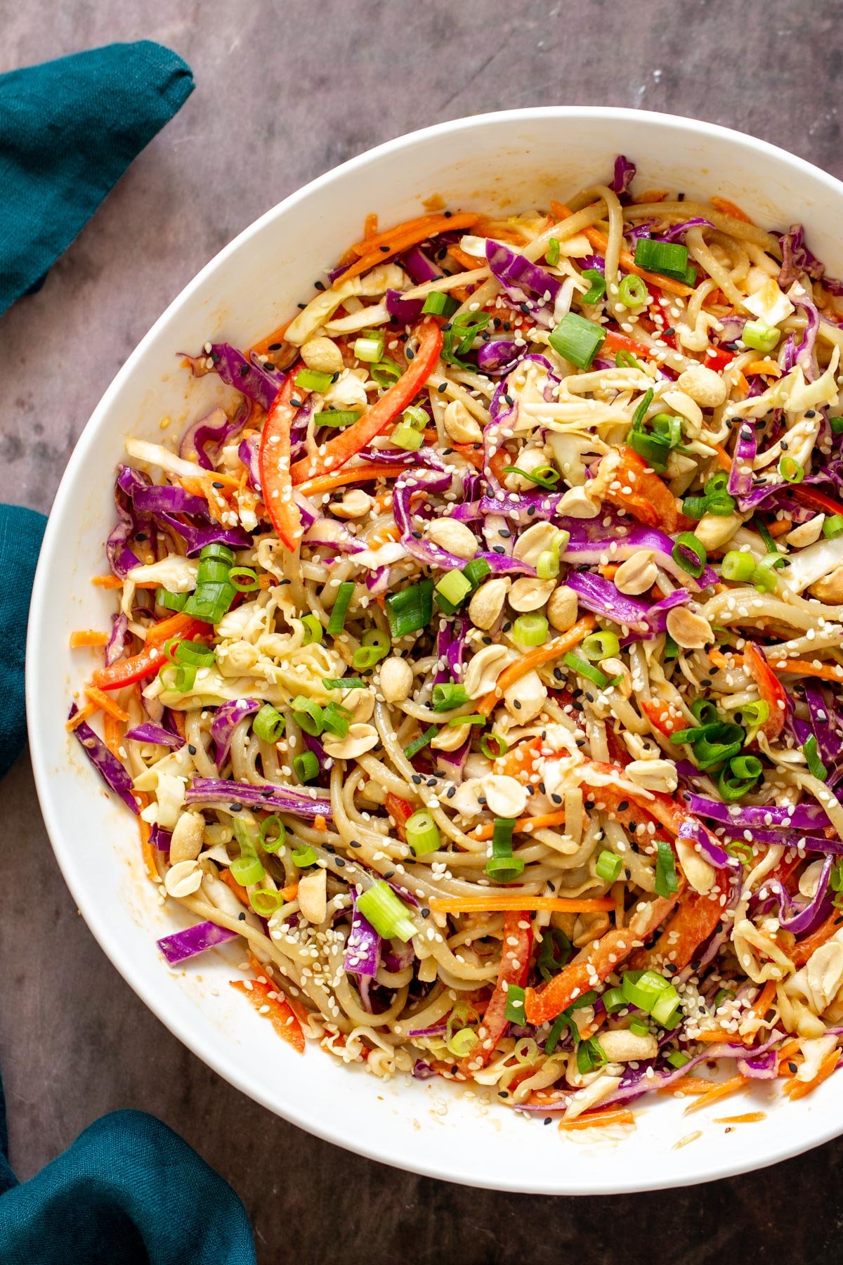 a bowl with peanut sesame noodle salad tossed with a creamy peanut dressing