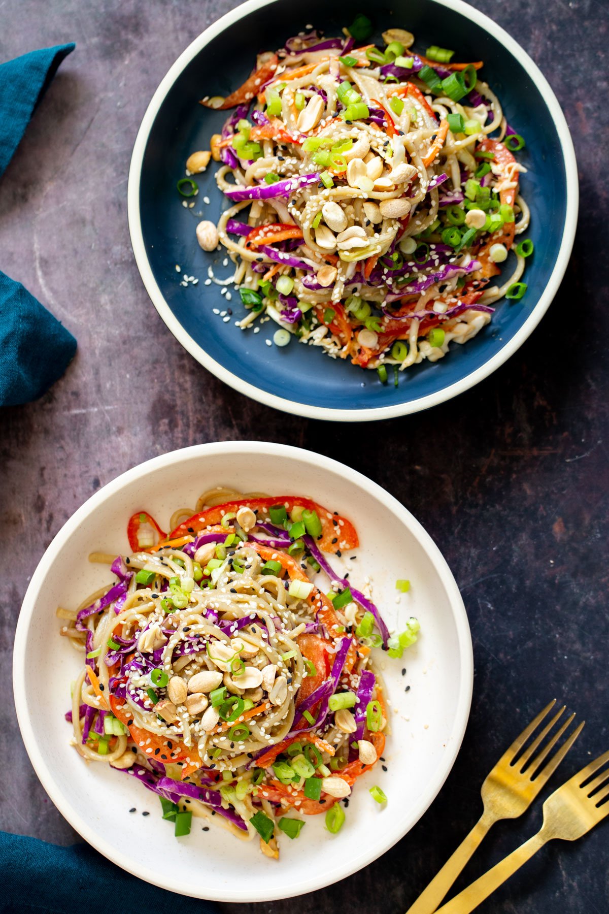 two plates with vegan sesame noodle salad with creamy peanut butter dressing