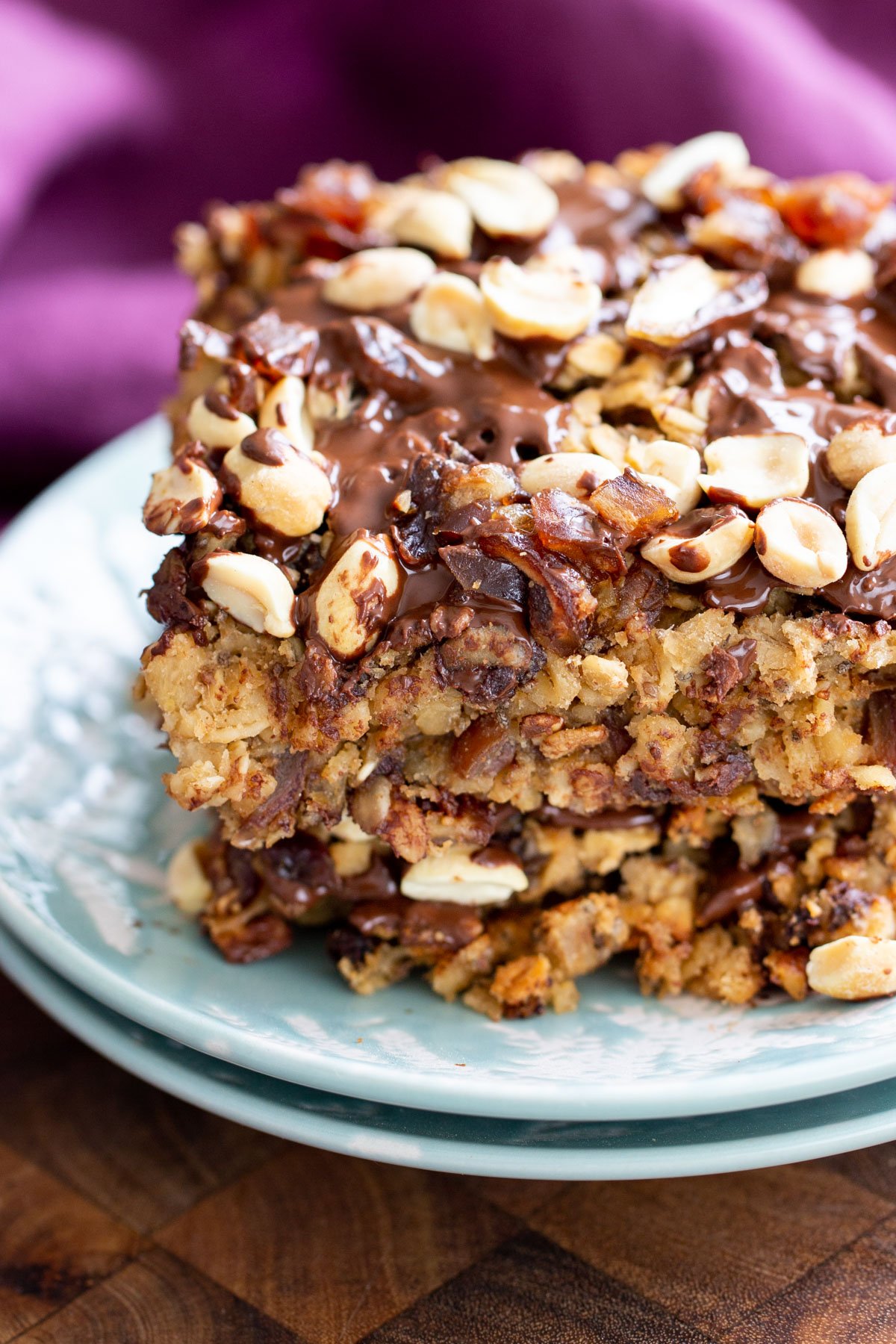 snickers baked oatmeals topped with peanuts stacked on top of each other