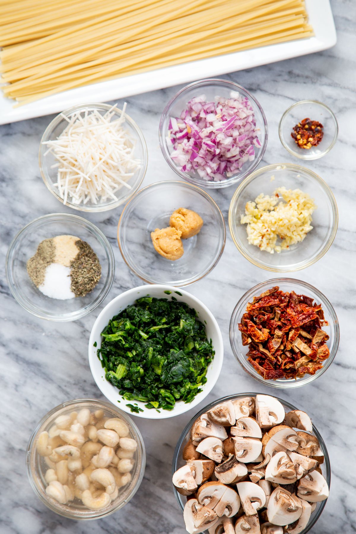ingredients needed for making creamy vegan mushroom pasta with sundried tomatoes