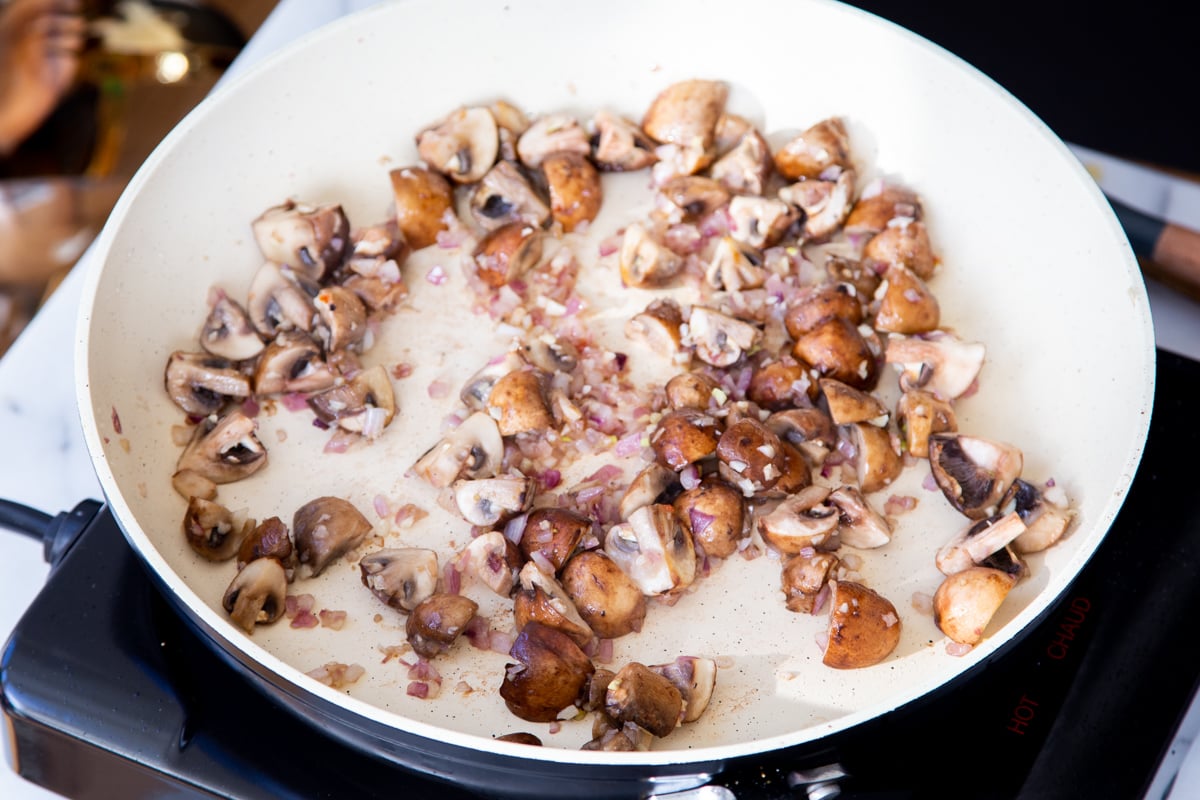 mushroom, onion and garlic in a sauteeing pan
