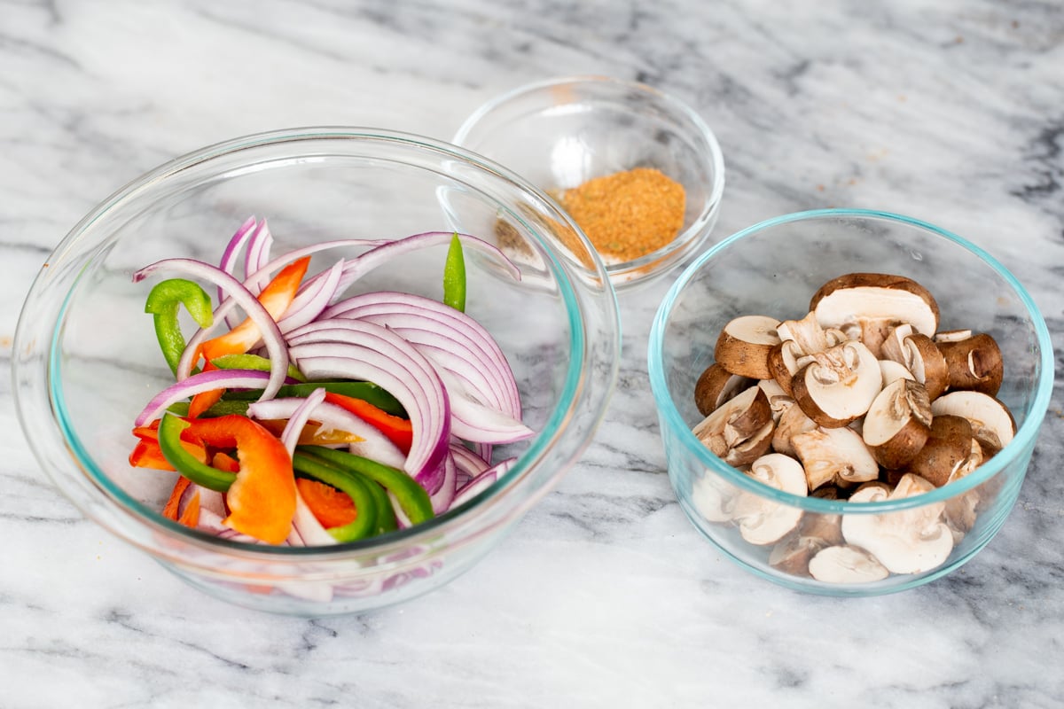 sliced veggies for vegan birria filling on a marble countertop