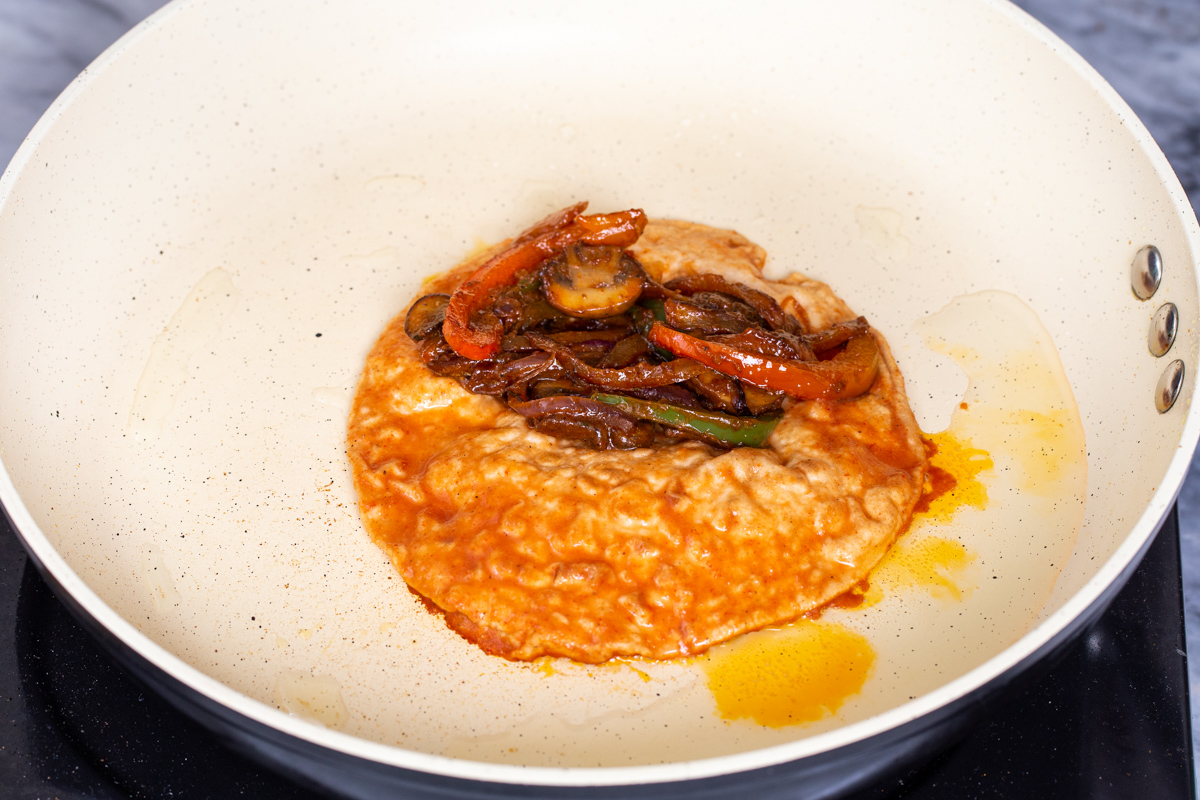 a tortilla topped with roasted red bell pepper