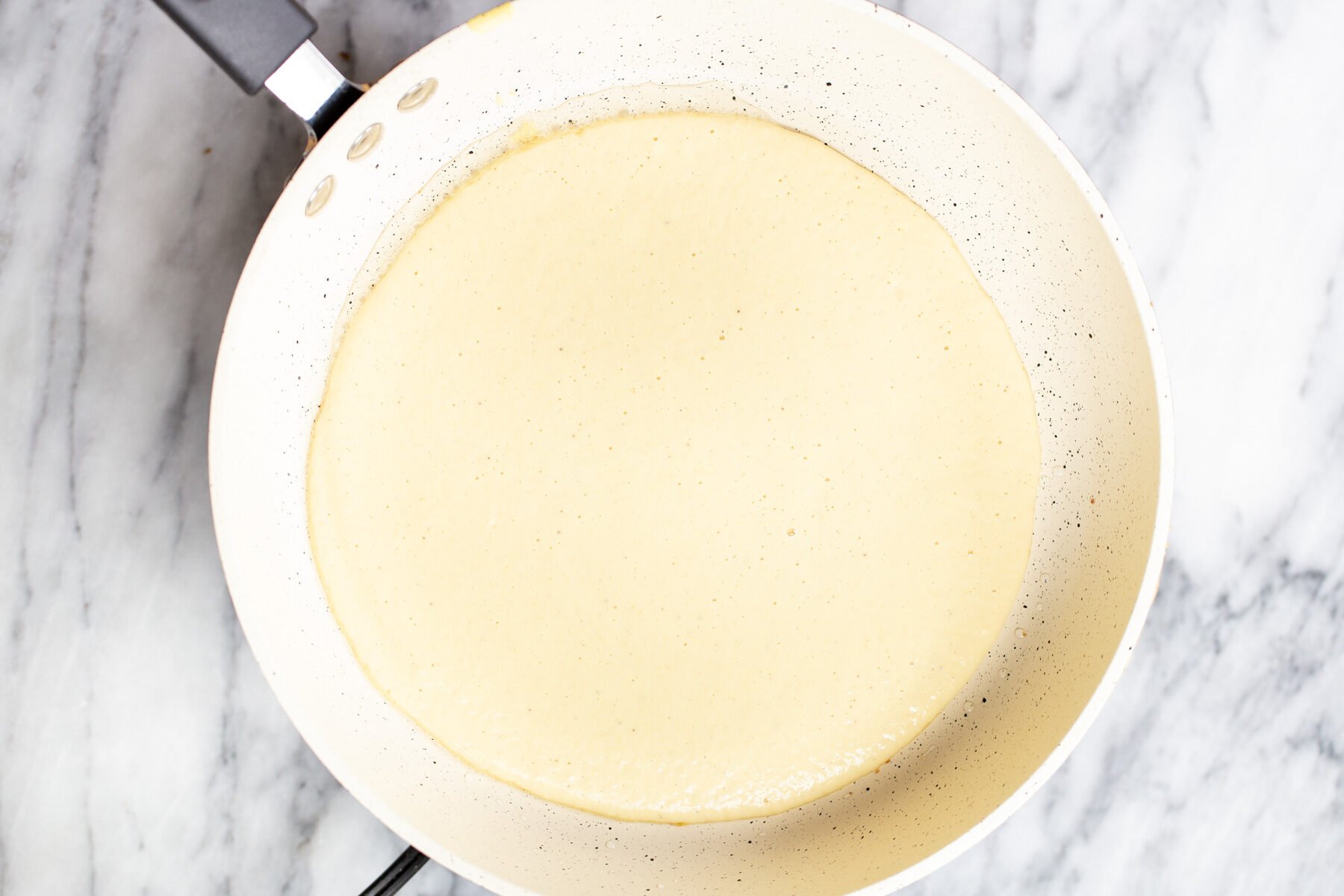 blended split yellow beans frying in a sauteeing pan