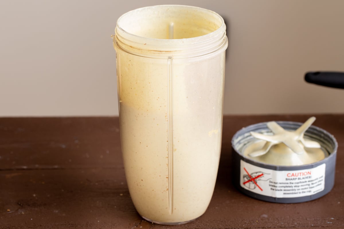 freshly blended pistachio lassi in the container of a blender