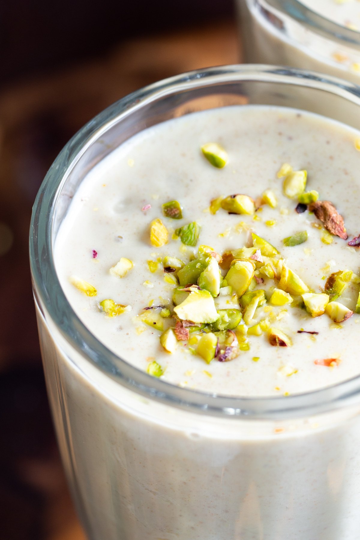 close-up of a glass of Indian pistachio lassi in a tall glass