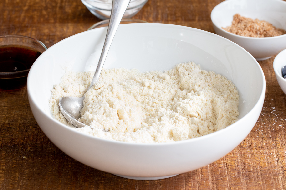 dry ingredients for making blueberry muffin cookies in a white dish