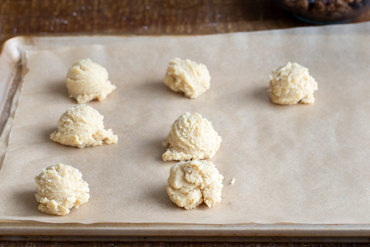 cookie dough balls on a baking sheet