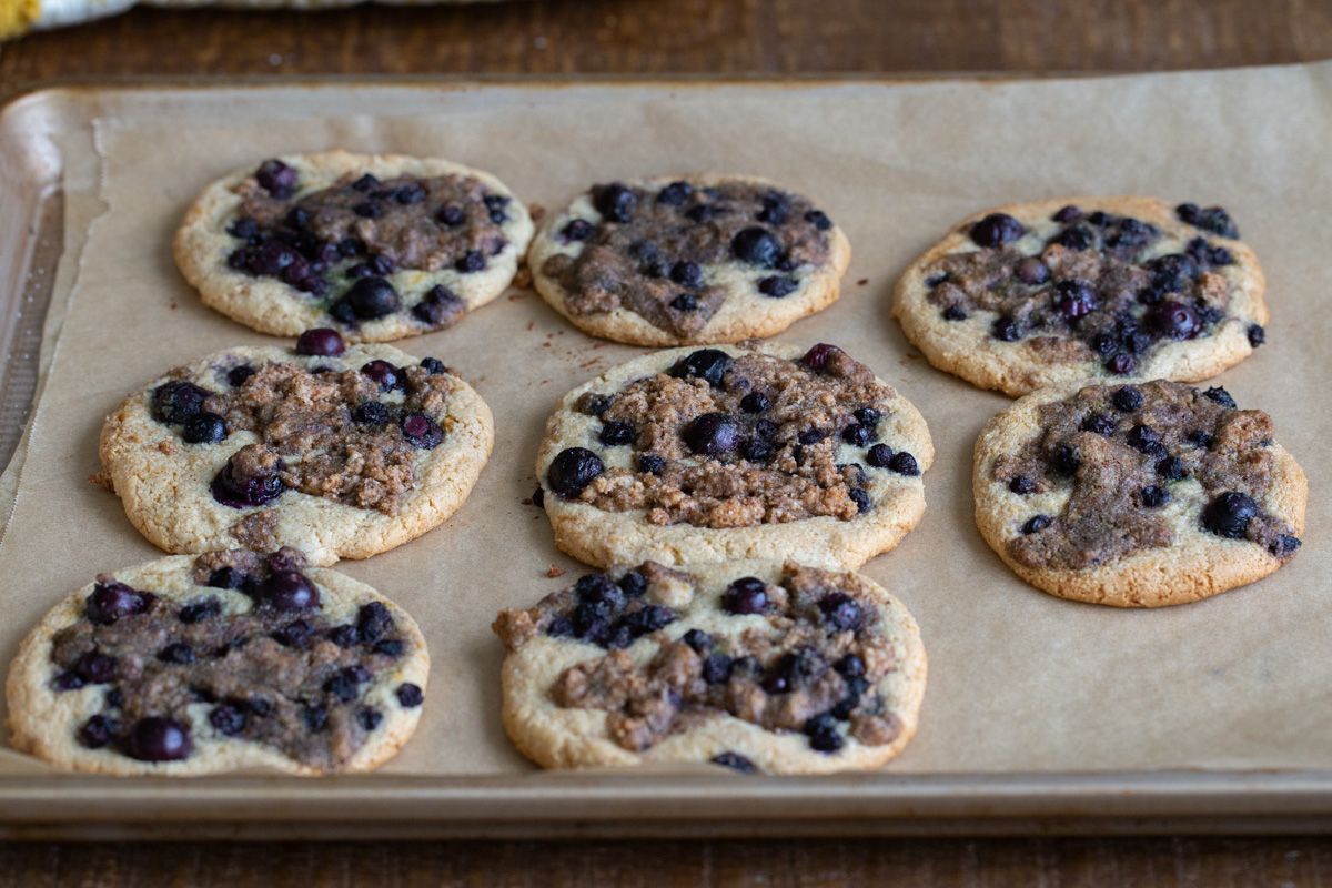freshly baked blueberry muffin cookies on a baking sheet