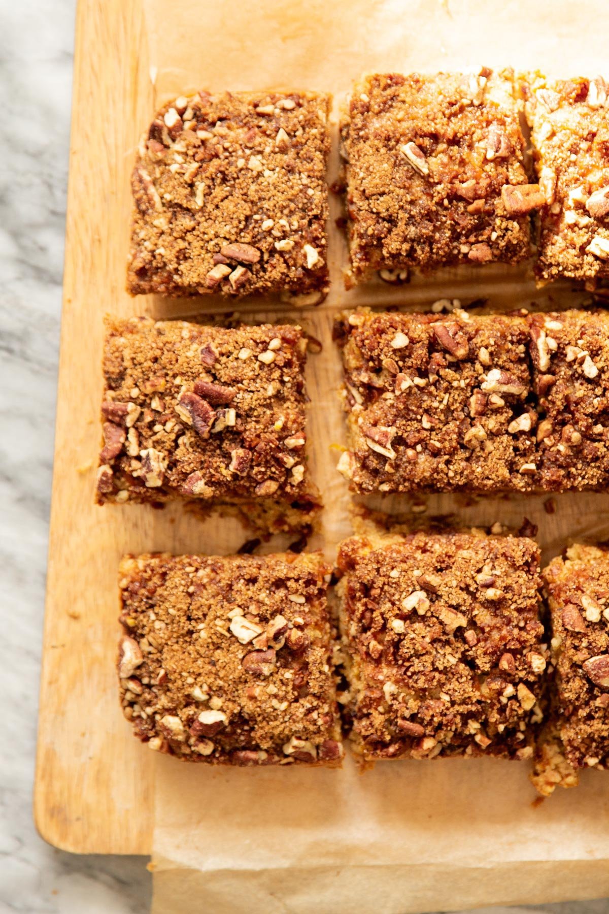 sliced vegan carrot cake bars on a sheet of parchment paper