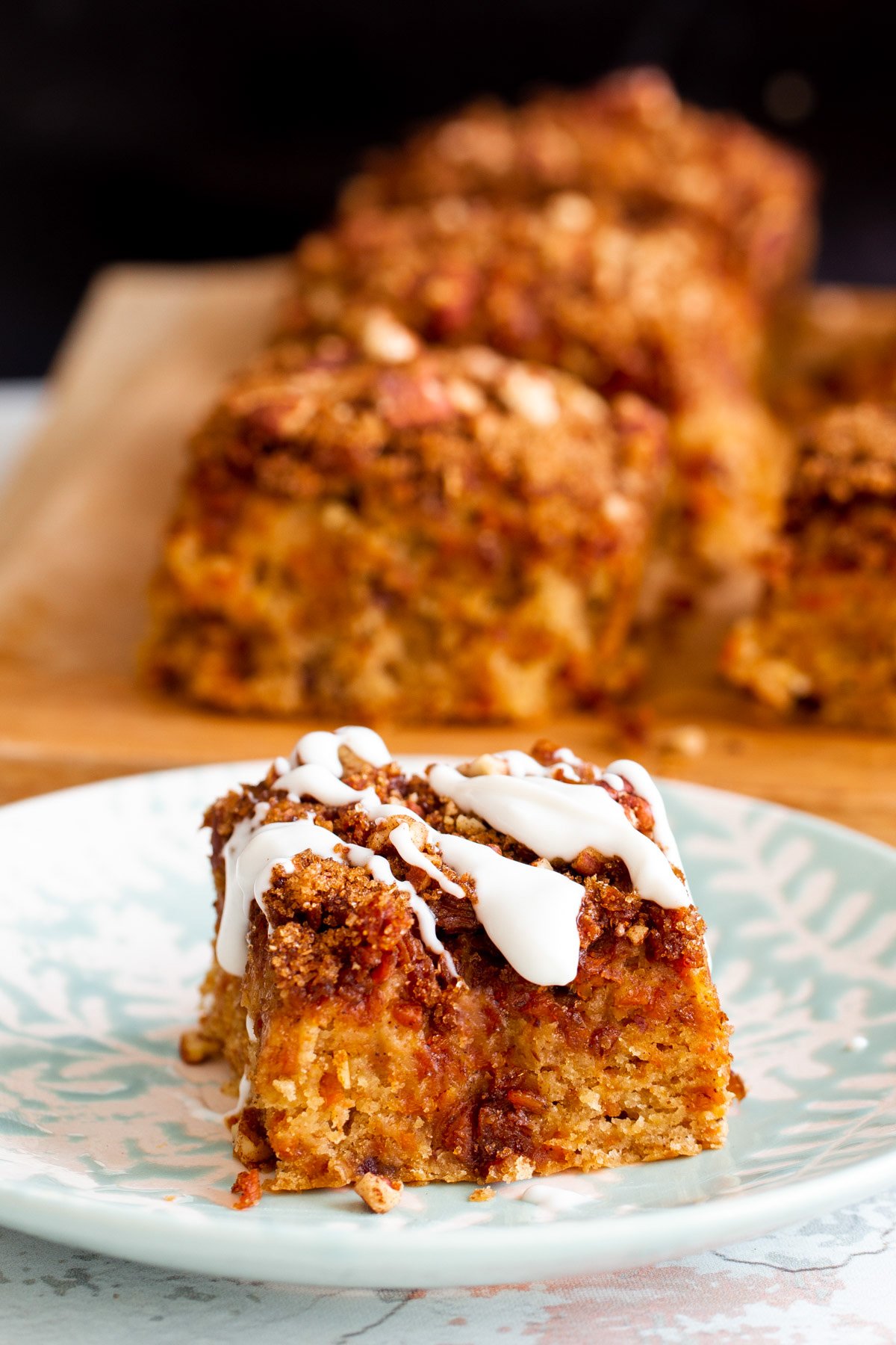 vegan carrot cake bar drizzled with vegan cream cheese icing