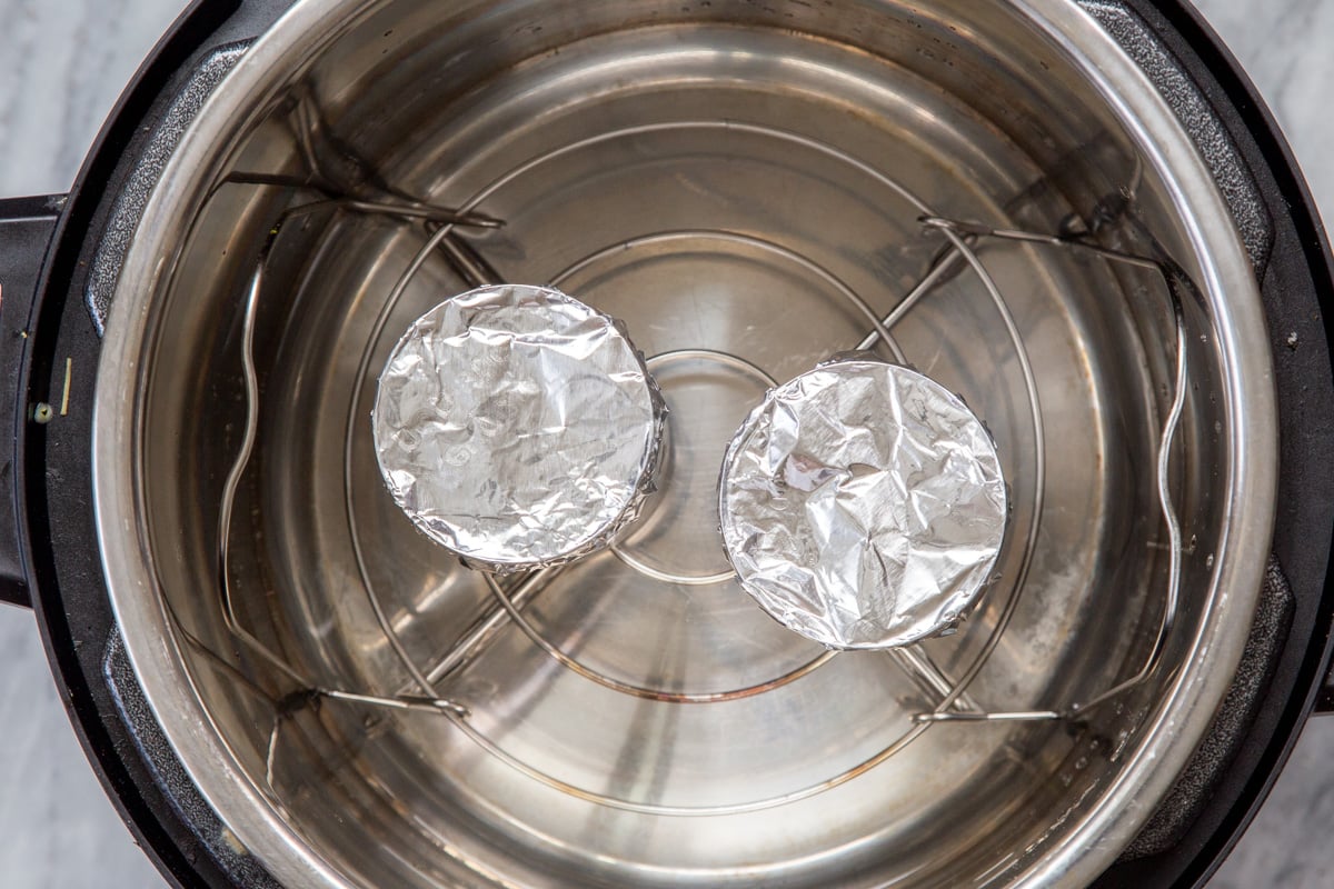 two tins covered with aluminum foil in an Instant Pot
