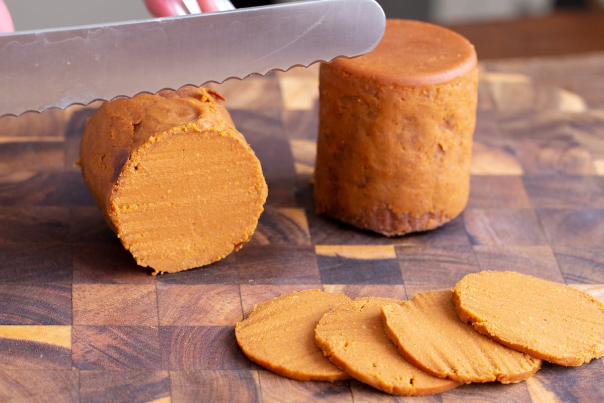 vegan pepperoni sausage being sliced