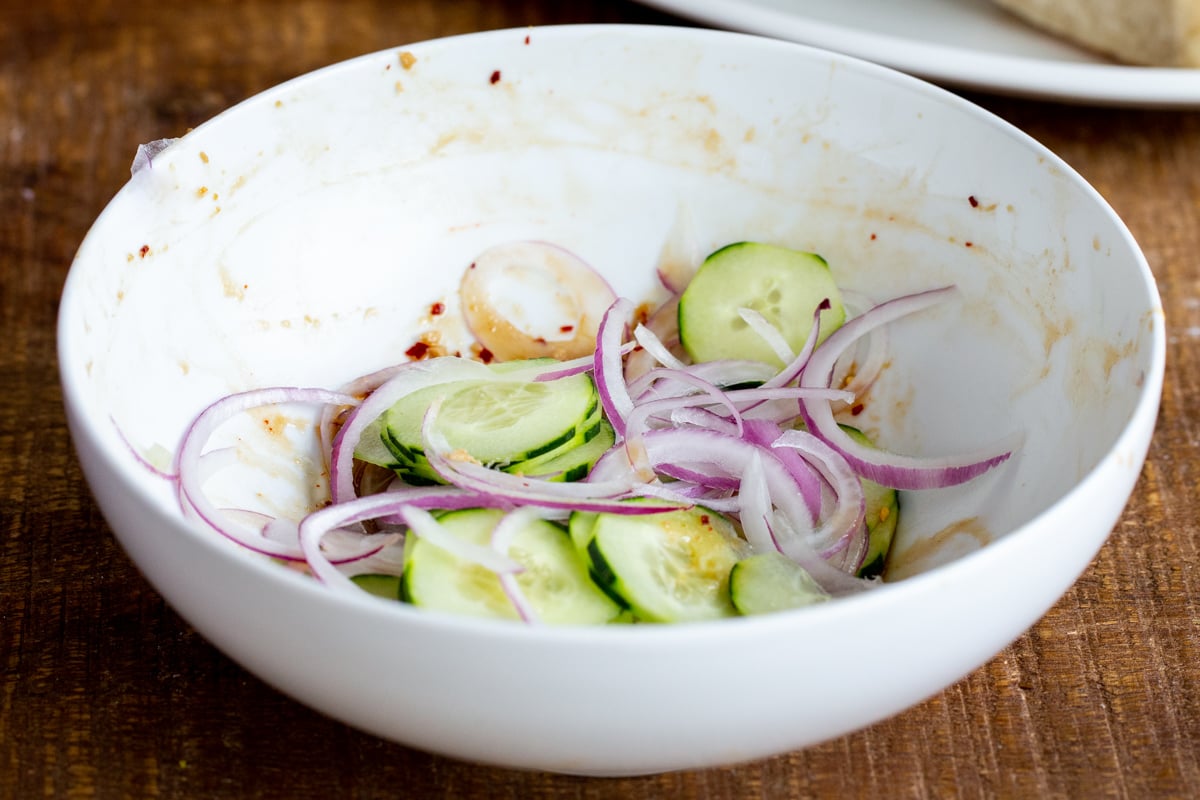 cucumber and onion slices in a small bowl