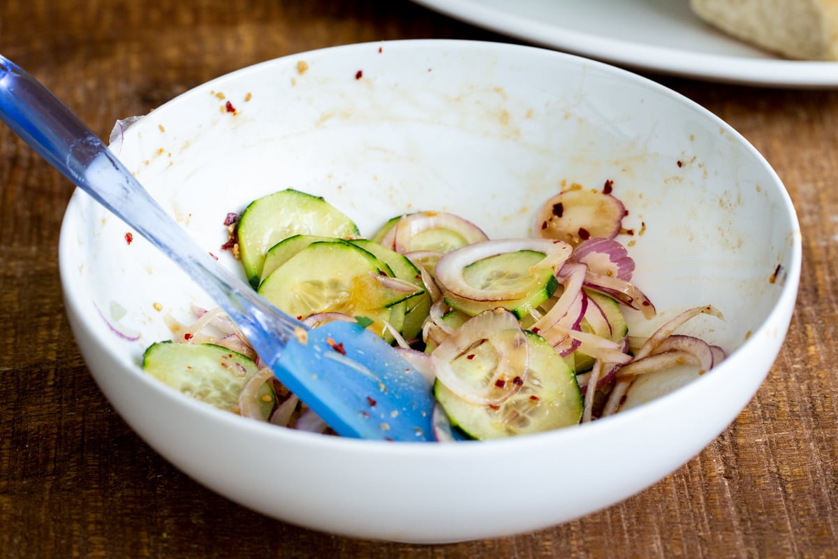 marinated cucumber and onion slices in a small bowl