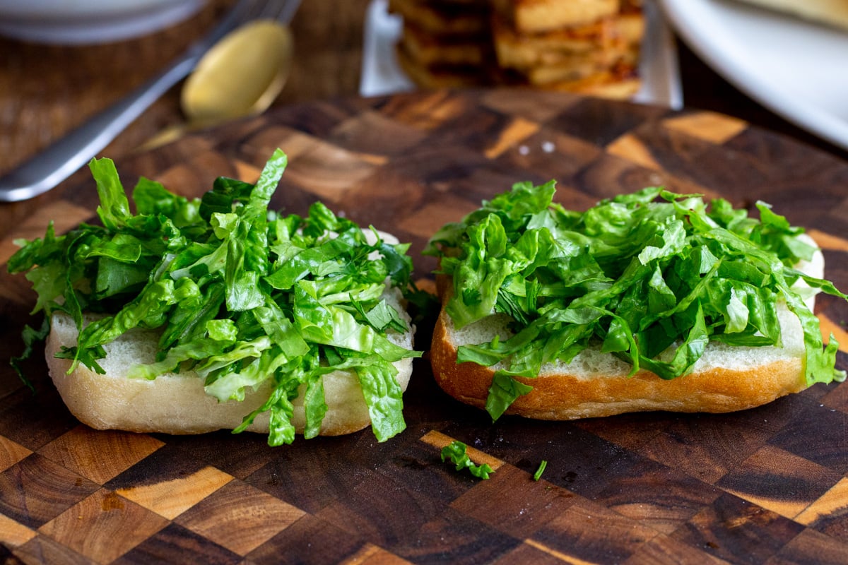 two bread halves topped with chopped lettuce