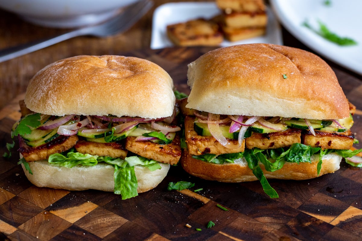 vegan chili garlic tofu sandwiches on a chopping board