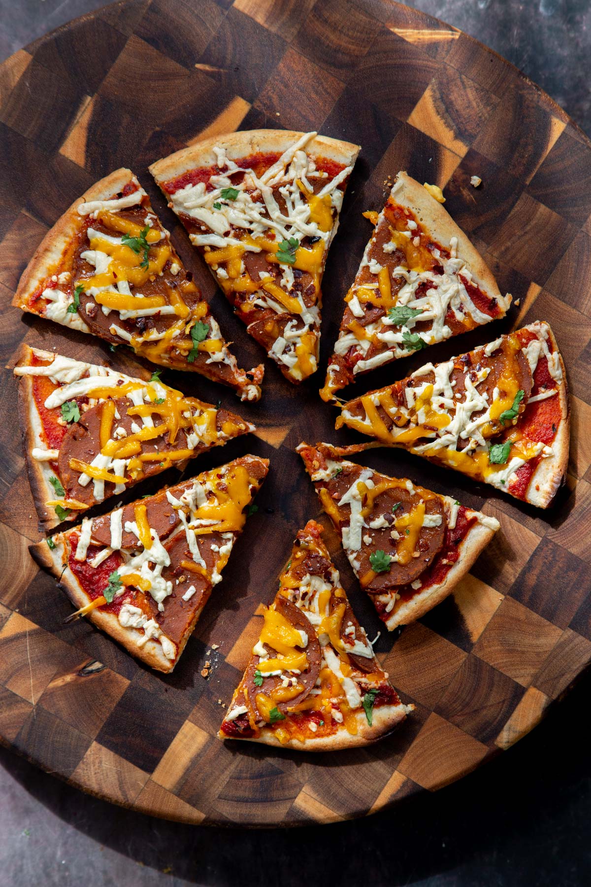 sliced vegan pepperoni and cheese pizza with almond flour crust