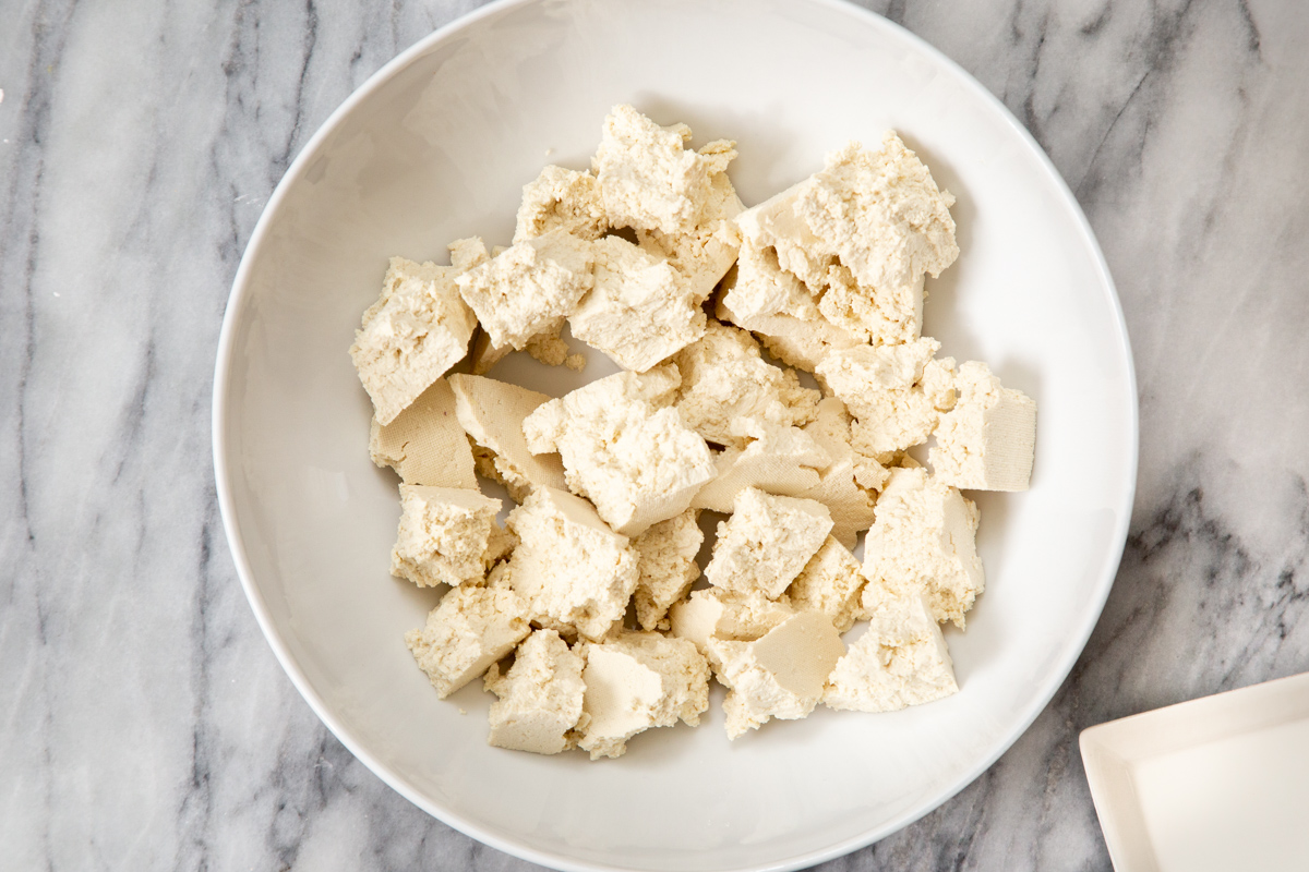 pieces on torn-up firm tofu in a white bowl