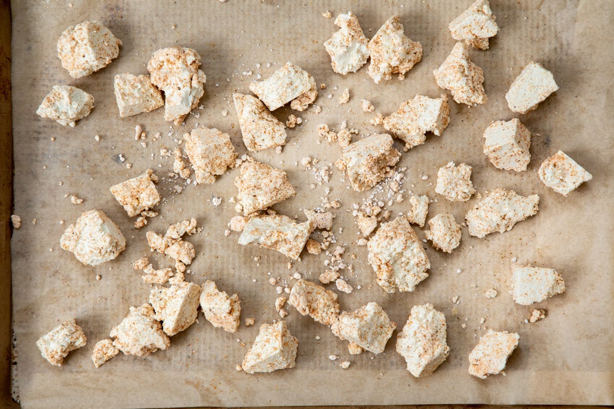 coated pieces of tofu on a baking sheet