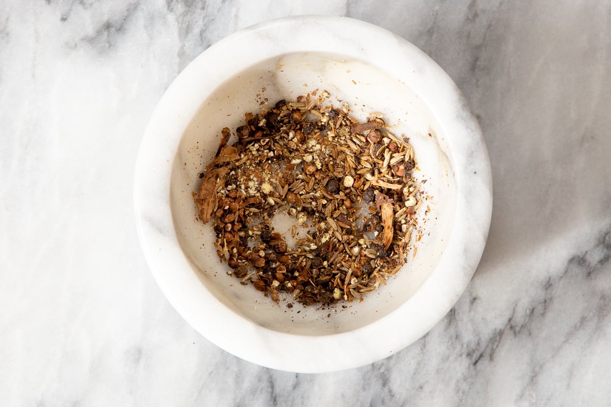 crushed whole spices in a small dish