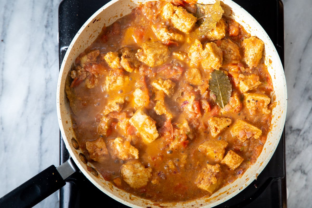 Khada Masala Murg Curry with Baked Tofu on a cooking plate in a sauteeing pan