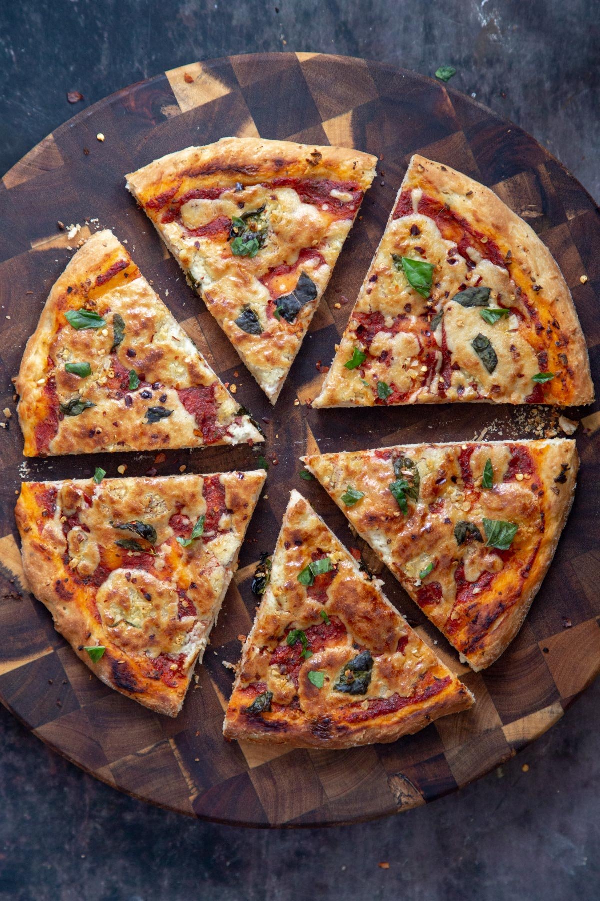overhead shot of a vegan mozzarella pizza topped with basil