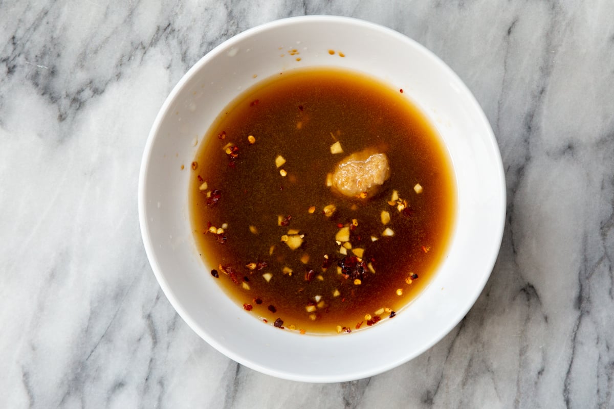 sweet spicy dressing in a small white bowl