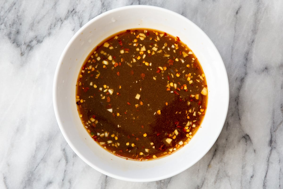 sweet and spicy dressing for lentil bowls in a small white dish