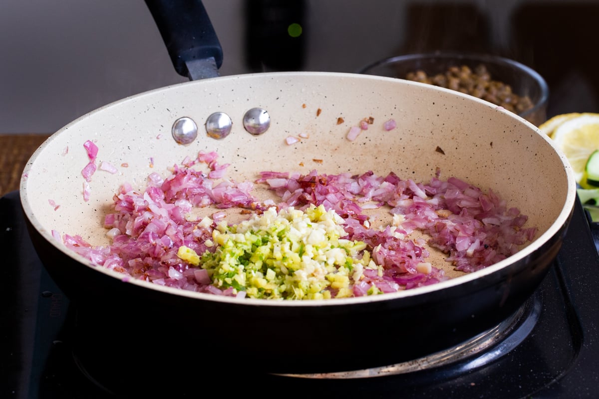 ginger and chilies being added to sauteed onion