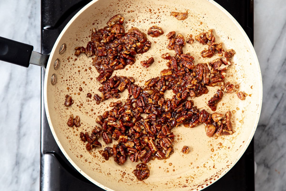 candied pecans in a sauteeing pan