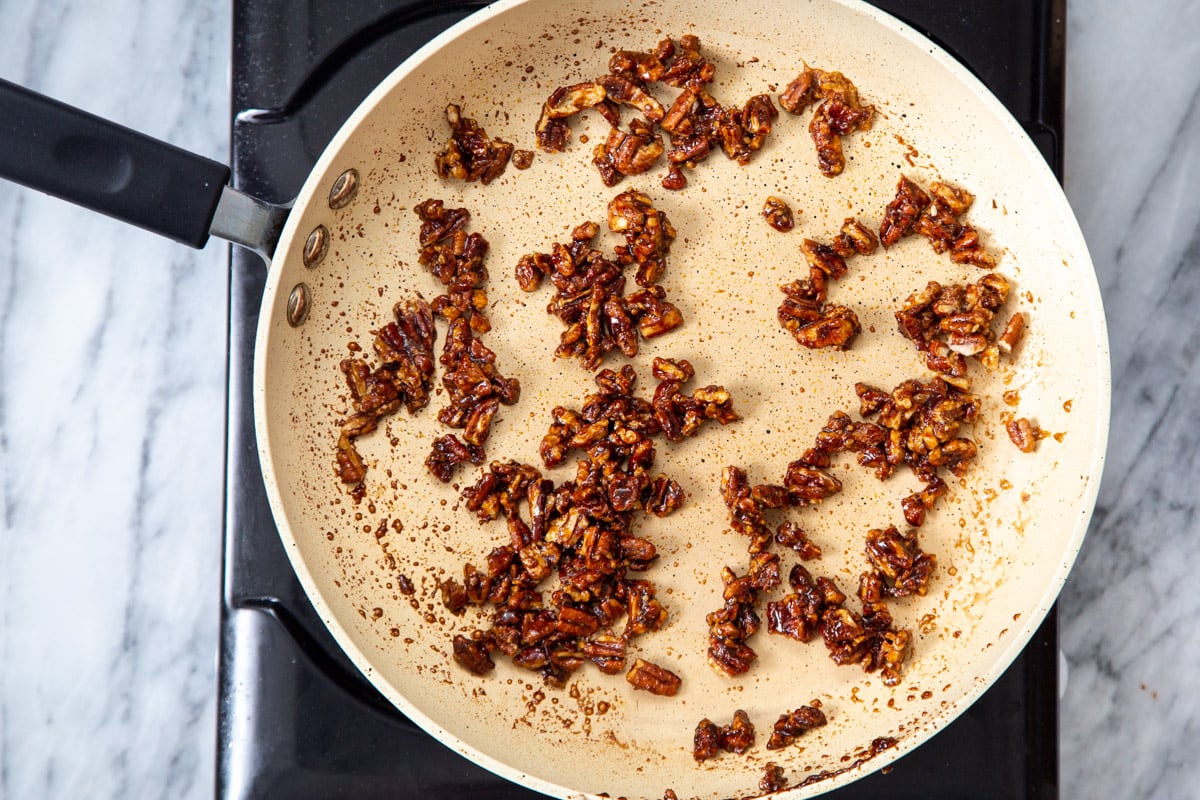 candied pecans in a sauteeing pan