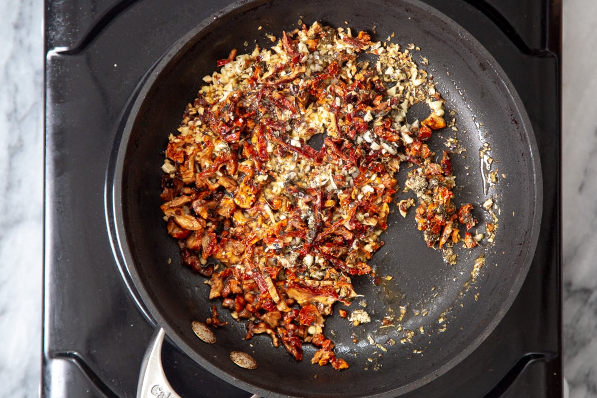 vegan chili garlic oil mix in a black sauteeing pan