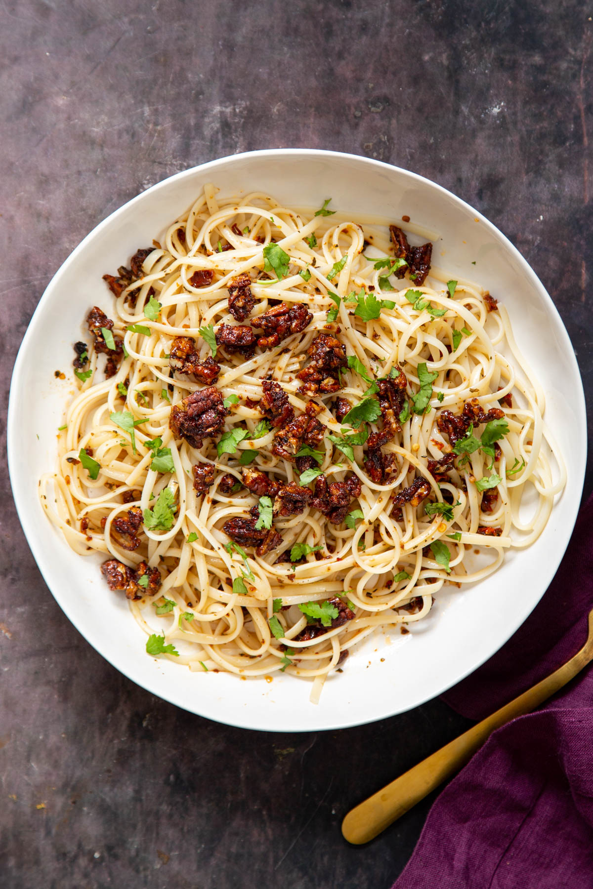 overhead shot of a serving of pasta topped with smoky pecans
