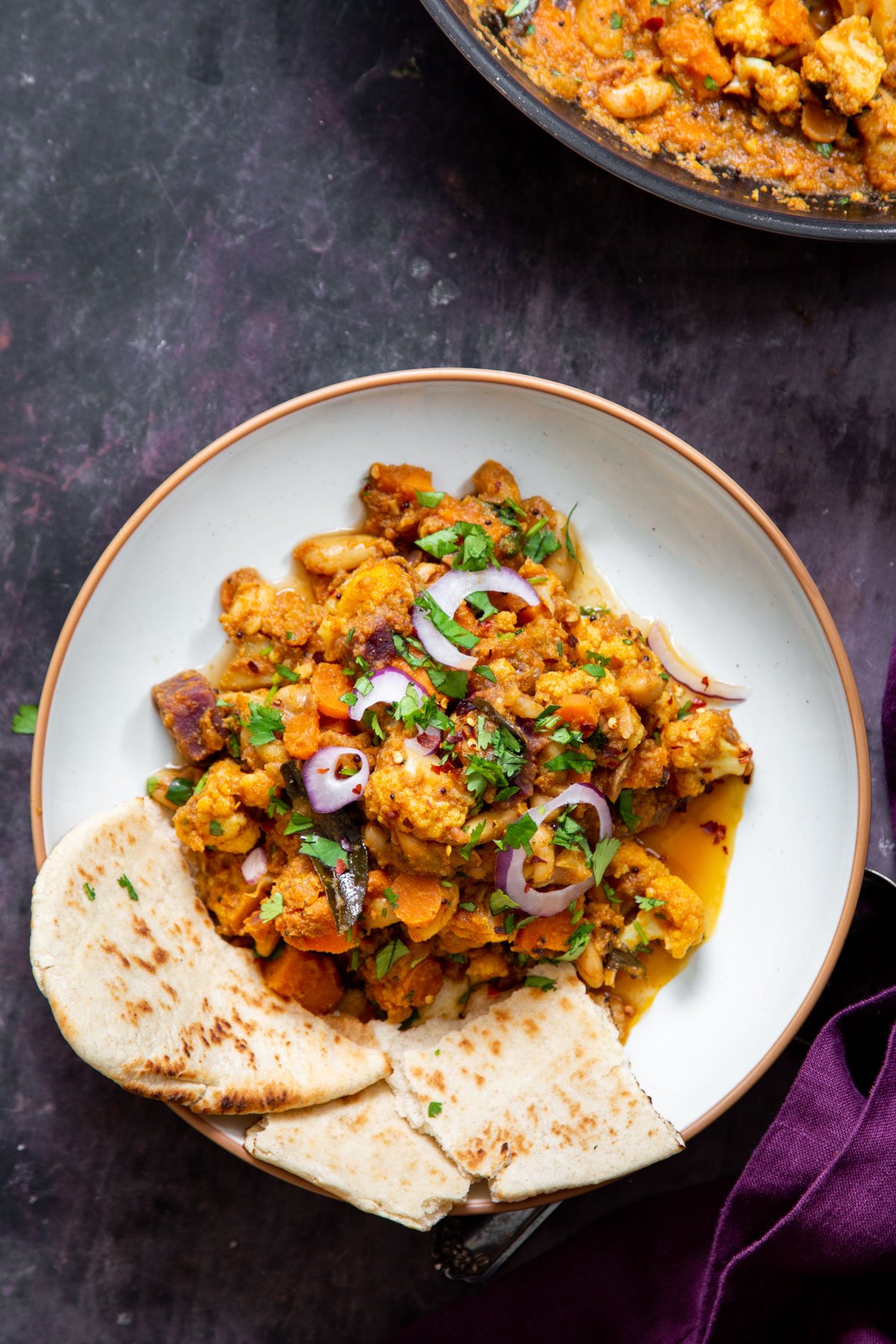 a serving of vegan malabar curry served with naan 