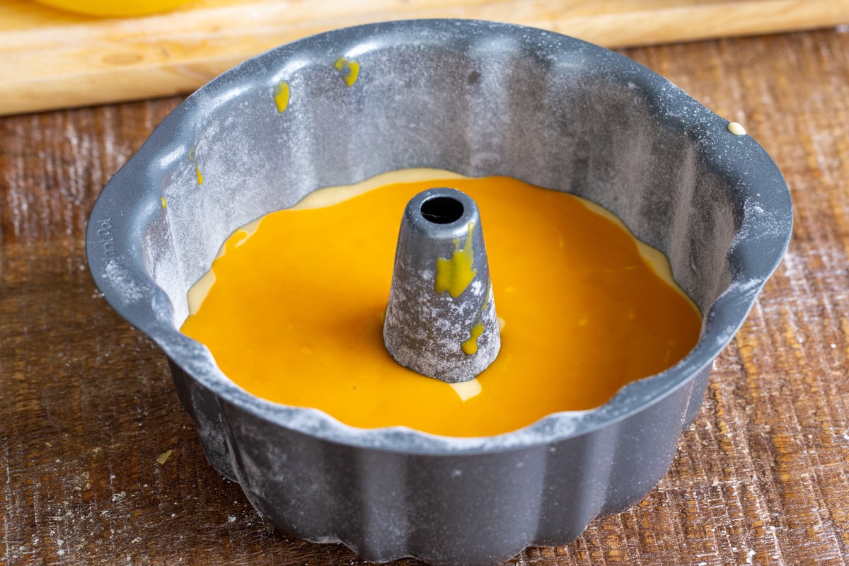bundt cake pan with cake batter and mango puree