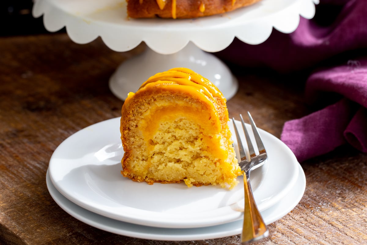 a slice of mango bundt cake with a fork on the side