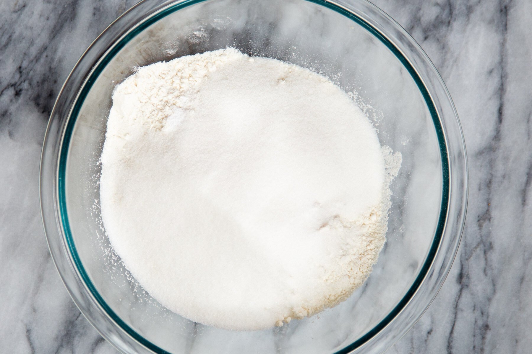 dry cake ingredients in a class bowl