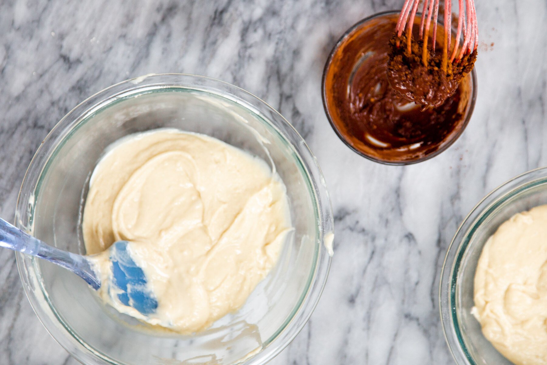 chocolat and vanilla cake batter in two separate bowl ready to be used for marble cake recipe