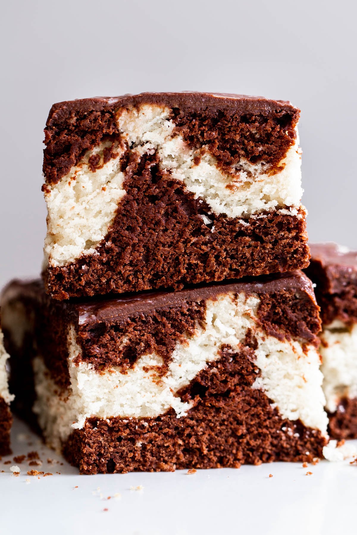 two stacked slices of vegan marble cake with chocolate ganache