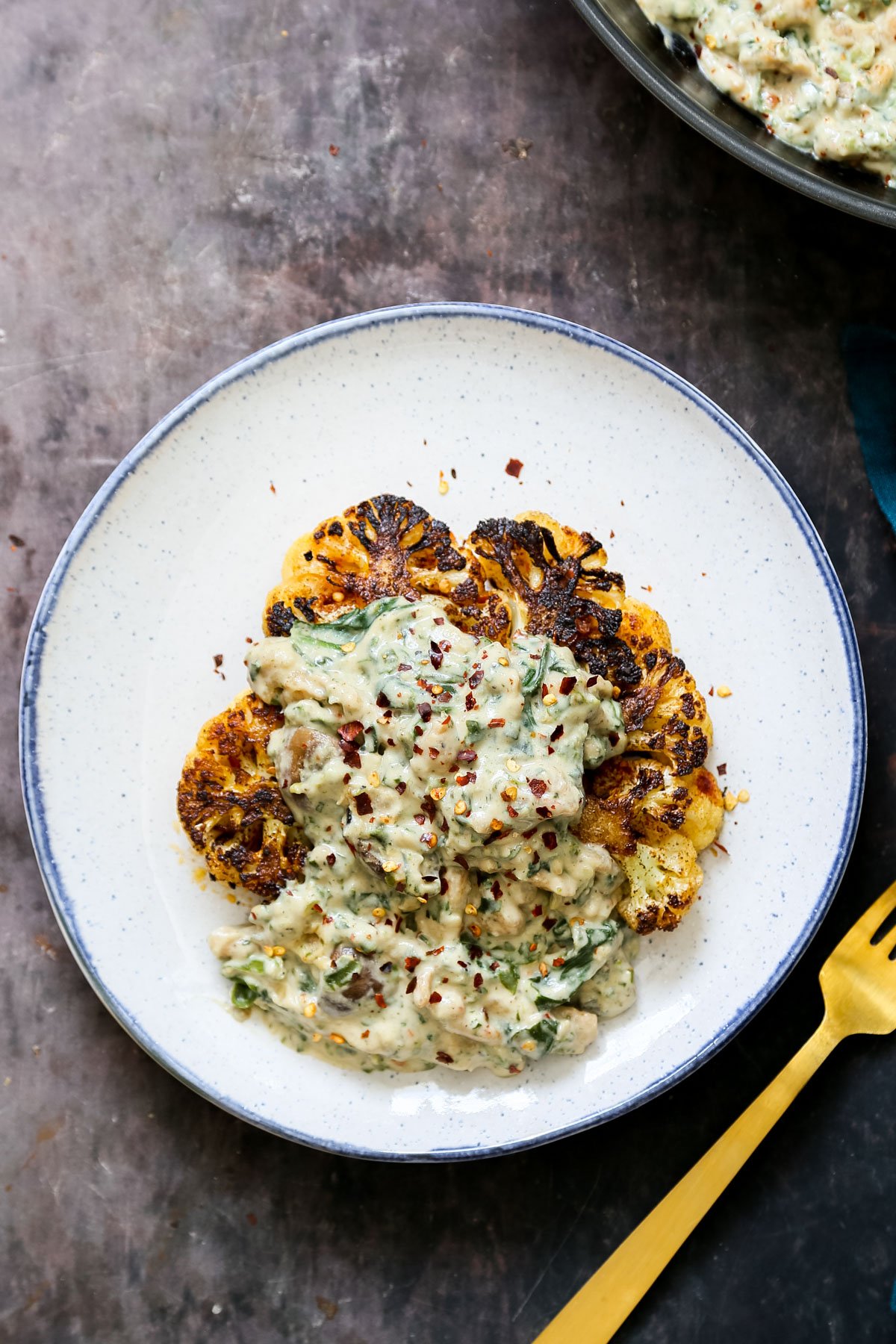 cauliflower steak topped with vegan soycurl florentine sprinkled with red pepper flakes