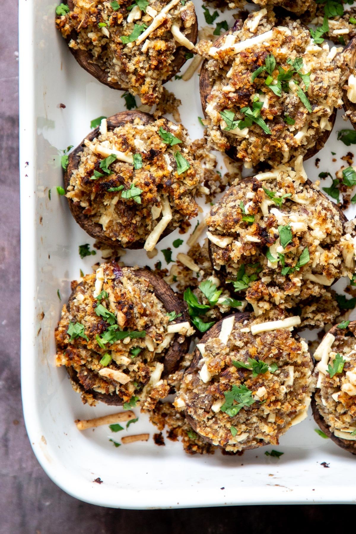 stuffed vegan mushrooms with breadcrumb filling in a white casserole dish