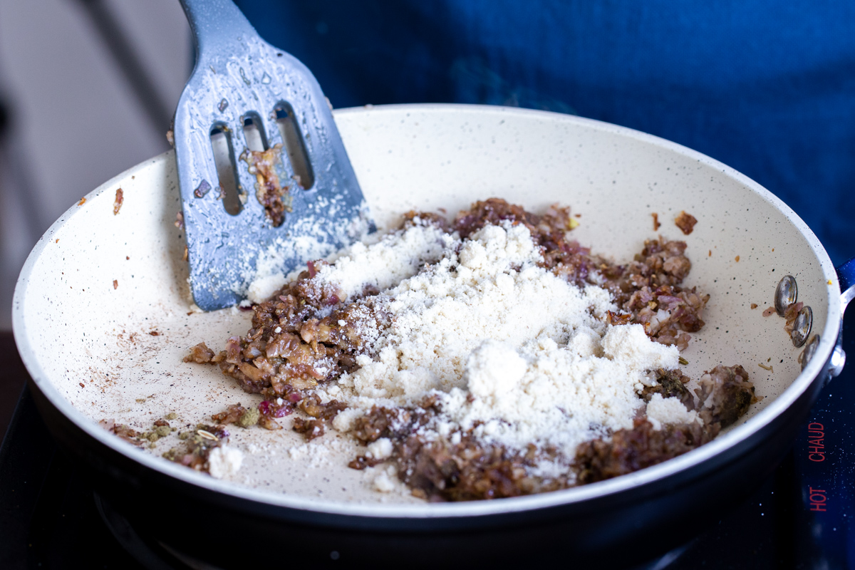 filling for vegan stuffed mushrooms being sauteed in a pan