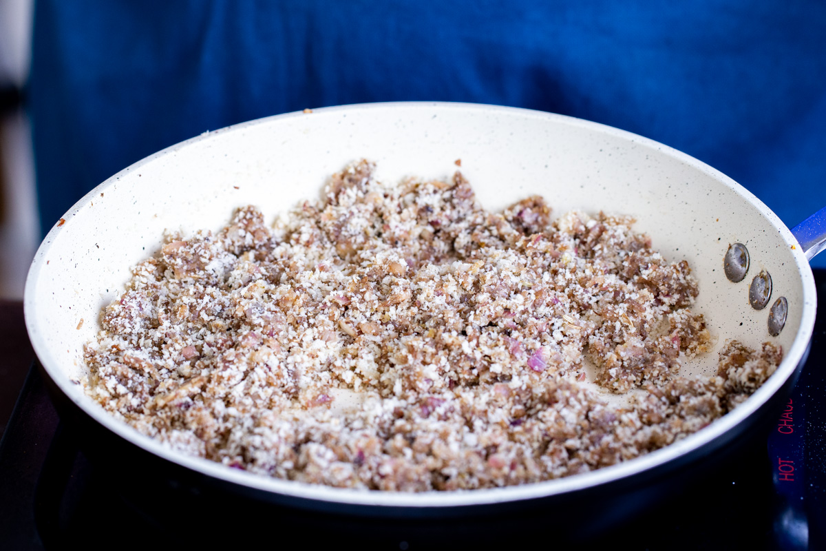 sauteed vegan mushroom stuffing in a white saucepan