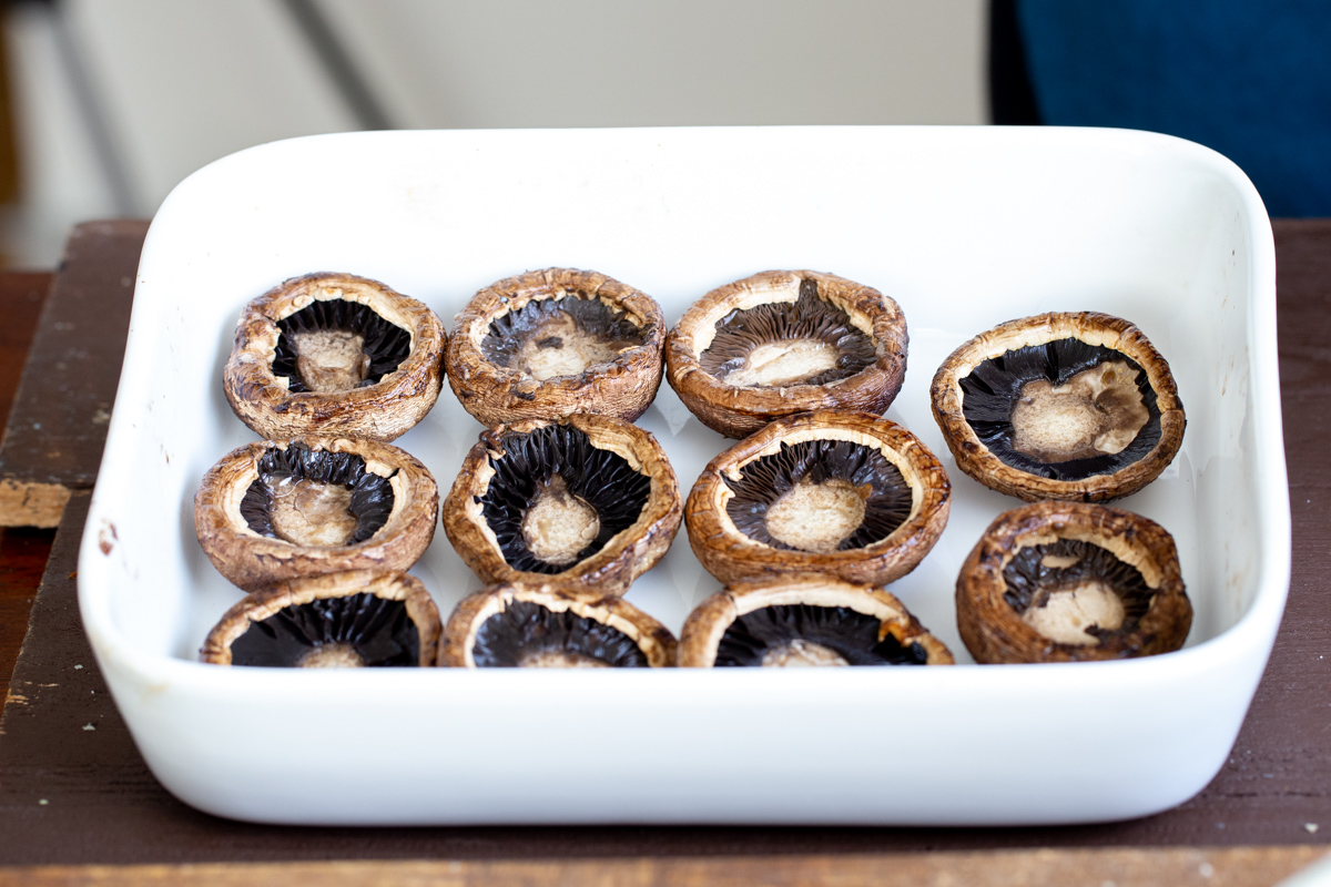 baked cremini mushroom caps in a casserole dish